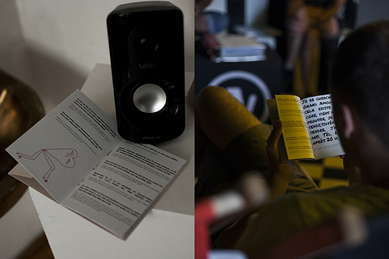 Landscape photo, divided into two halves. The left half of the image shows a detailed view of the white base from above. A zine is clamped under the black speaker, which is opened. Both sides show black printed text, the left side also has a pink illustration of a running heart. The right half of the picture shows the view over the shoulder of a person with short hair, who holds a zine in his hand and reads in it. In the background sit blurred other people.